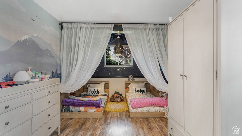 Bedroom featuring wood finished floors and a closet
