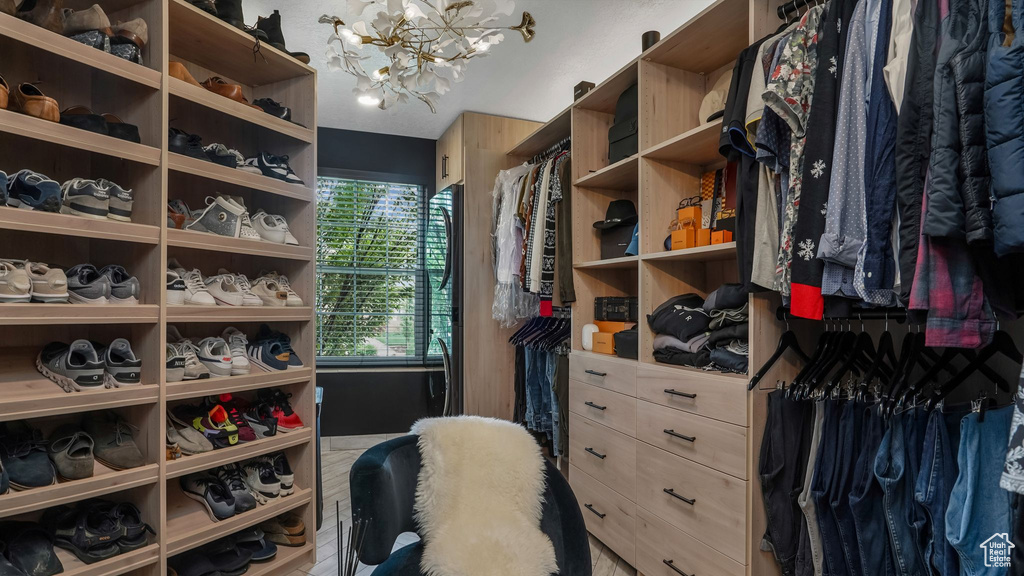 Walk in closet featuring a chandelier