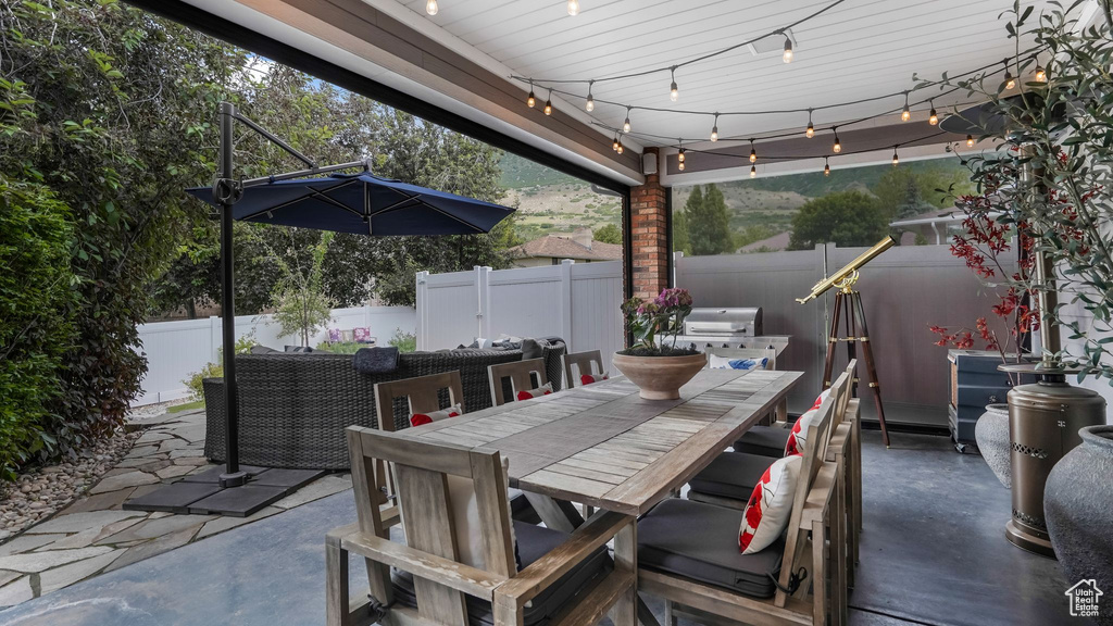 Fenced backyard featuring outdoor dining space and a patio area