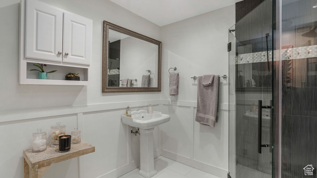 Full bathroom featuring a shower stall and tile patterned floors