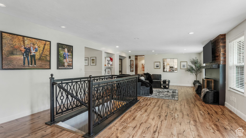 Living area with wood finished floors, a fireplace, and recessed lighting