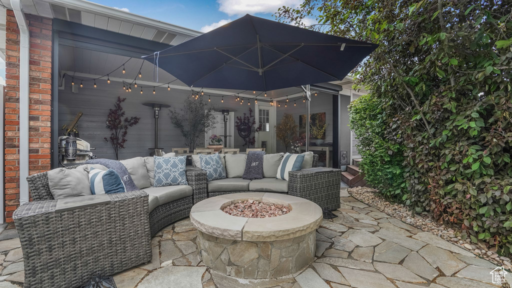 View of patio / terrace featuring an outdoor living space with a fire pit