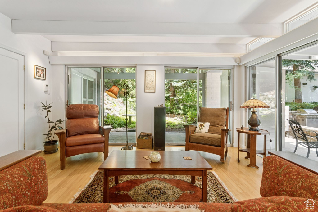 Living room with wood finished floors and beam ceiling