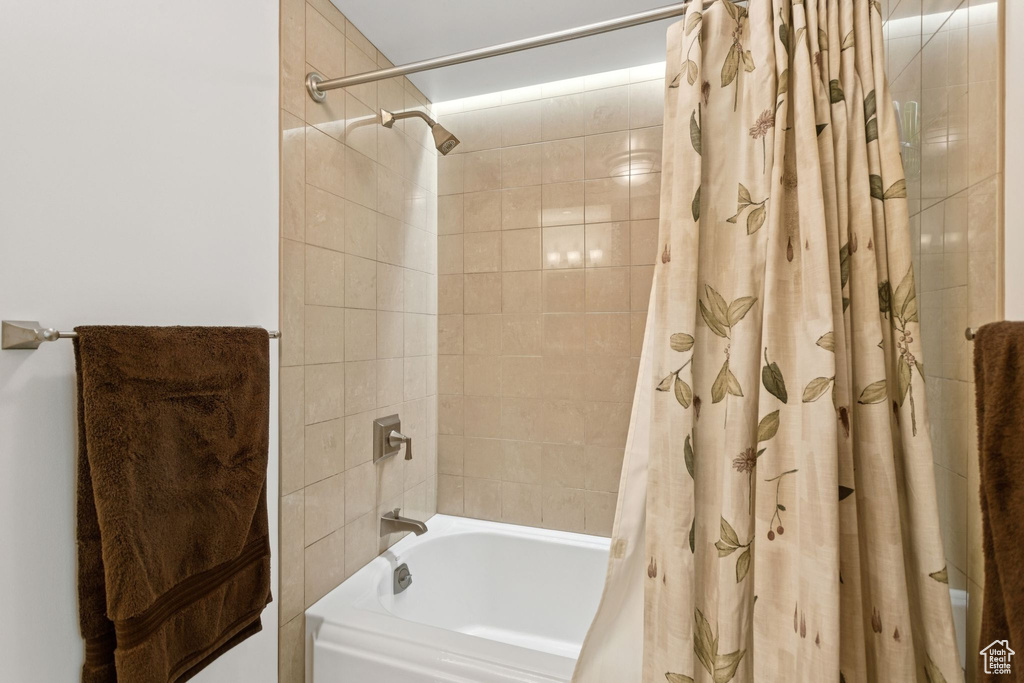 Full bathroom featuring shower / bath combination with curtain