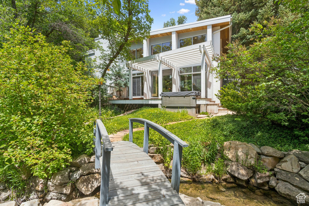 Back of house featuring a pergola