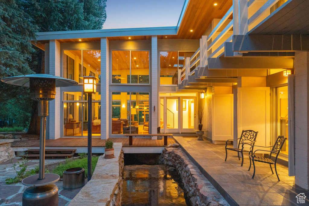 Rear view of house featuring a patio area and stairway