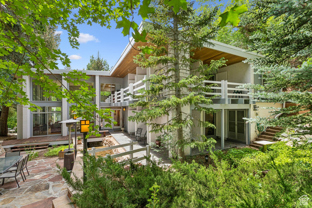 Back of house featuring a balcony and a patio area