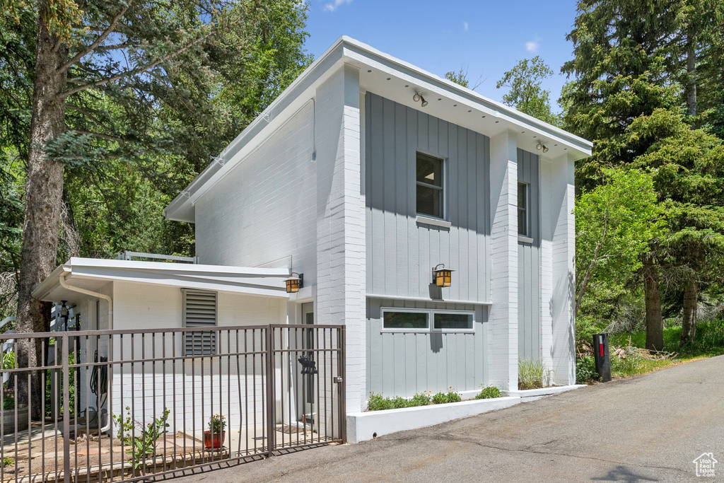 View of front of property with a fenced front yard and board and batten siding
