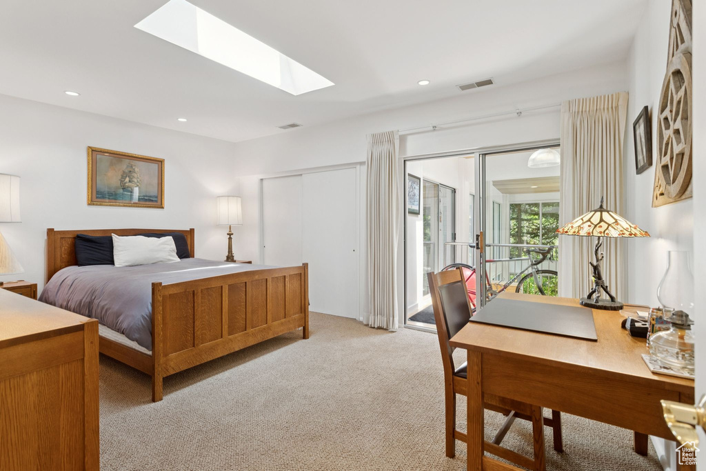 Bedroom featuring access to outside, carpet, a skylight, and recessed lighting
