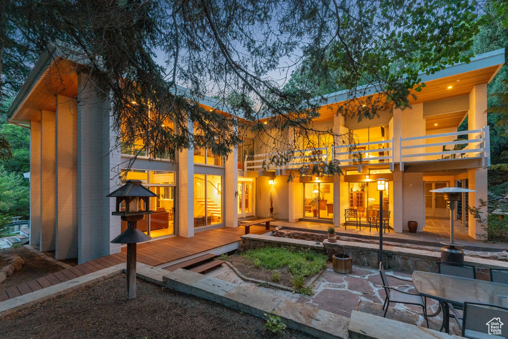 Back of house featuring a balcony and a patio