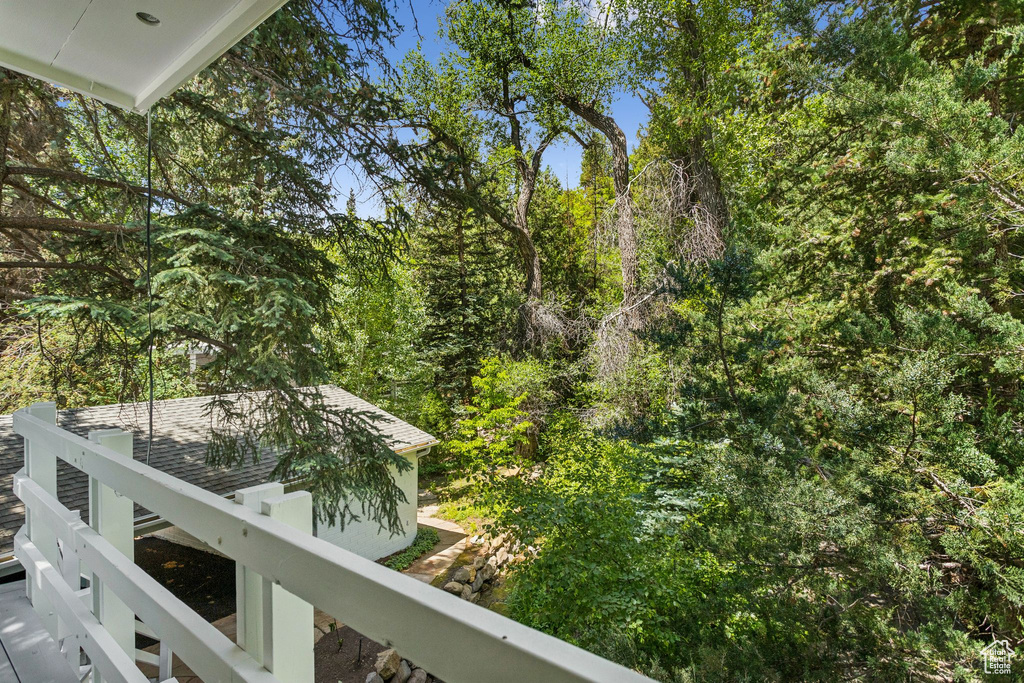Balcony featuring a view of trees