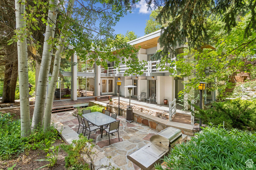 View of patio / terrace featuring outdoor dining area and a wooden deck