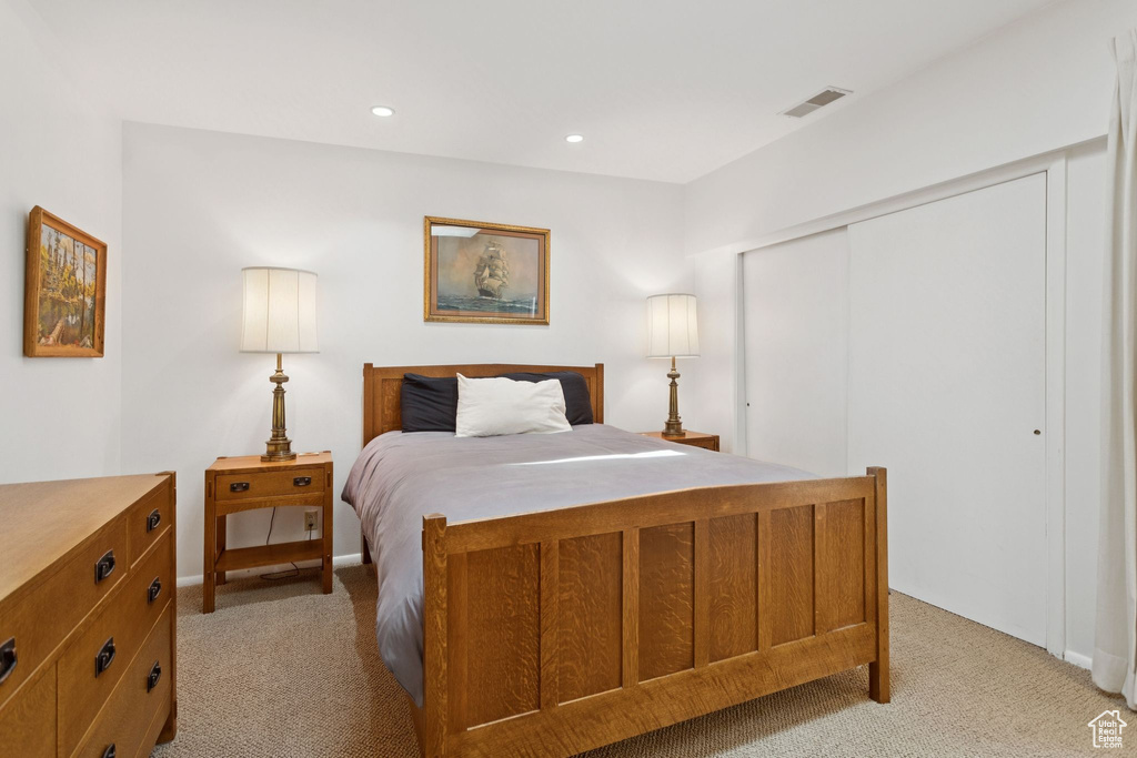 Bedroom featuring light carpet, a closet, and recessed lighting