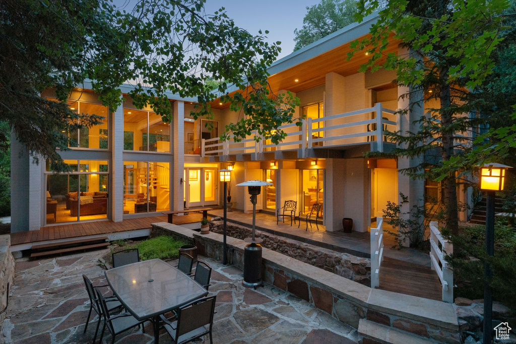 Back of house featuring a patio, a balcony, and outdoor dining space