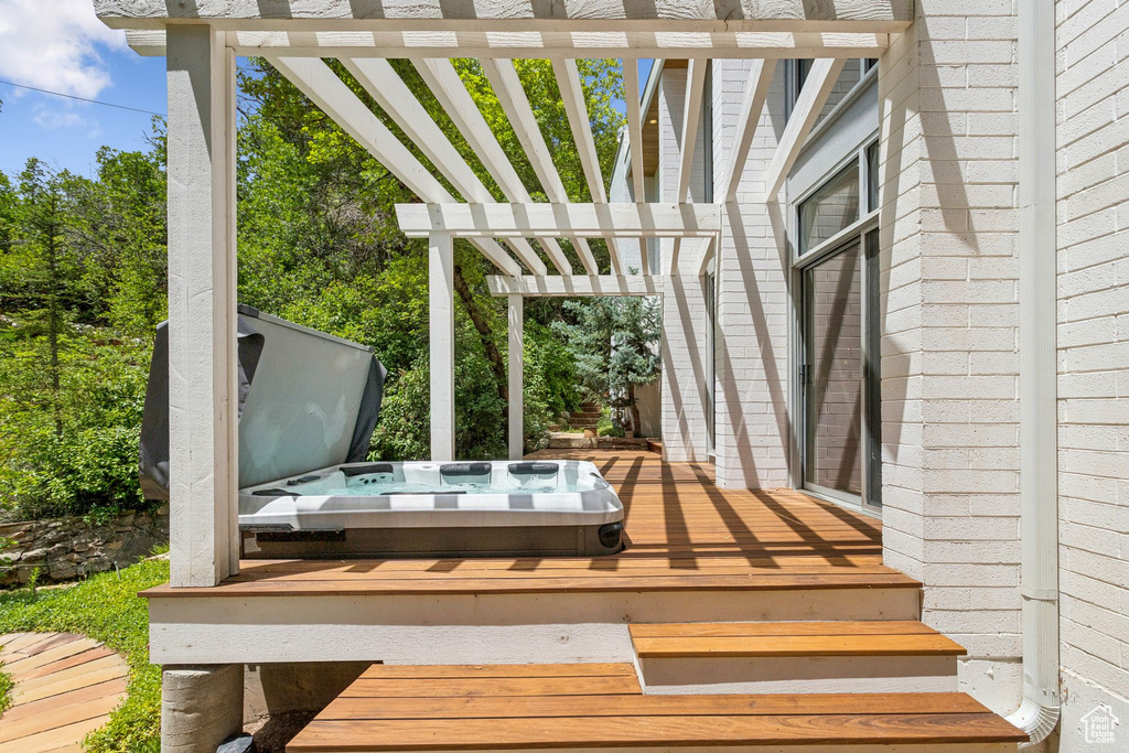 Wooden terrace with a covered hot tub