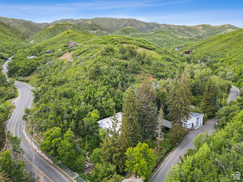 Aerial view of property and surrounding area with a mountainous background
