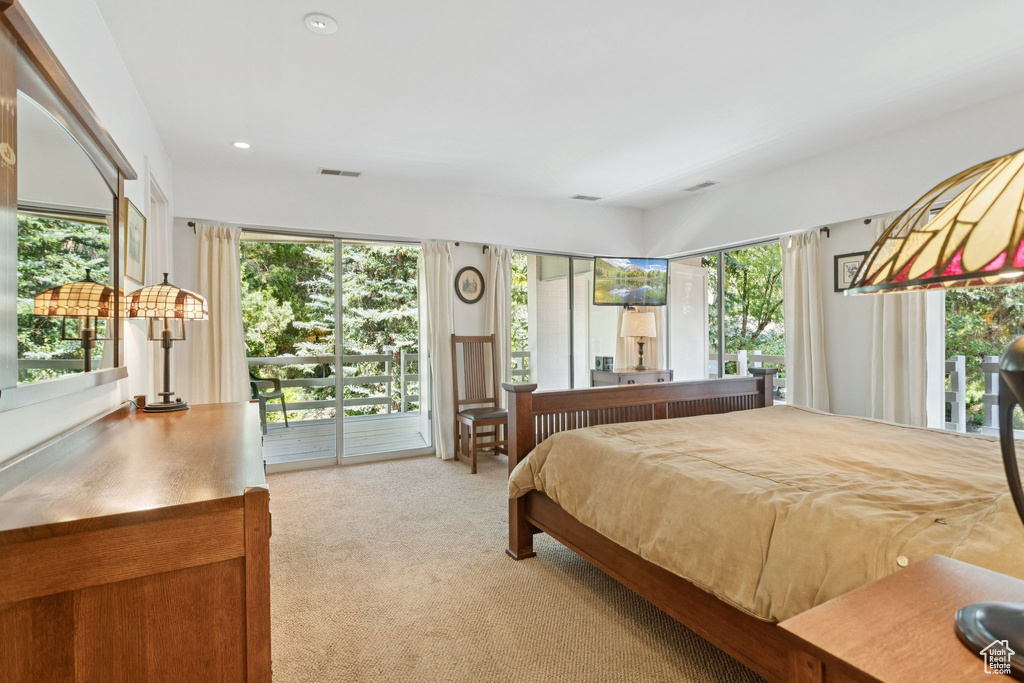 Bedroom with access to outside, light carpet, and recessed lighting