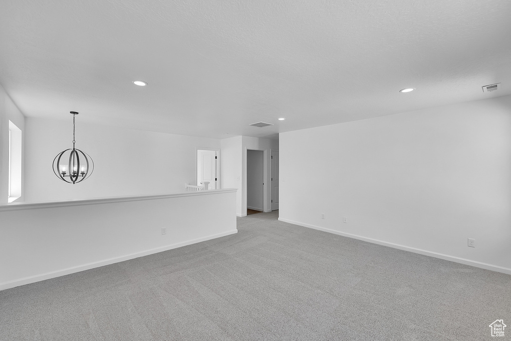 Empty room with recessed lighting, a chandelier, and carpet flooring