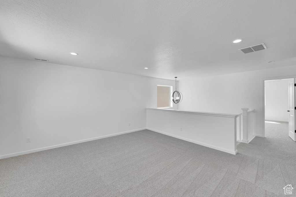 Unfurnished room with carpet floors, recessed lighting, and a textured ceiling