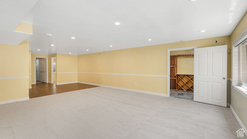 Below grade area with carpet flooring and recessed lighting