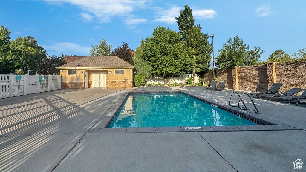Community pool with a patio