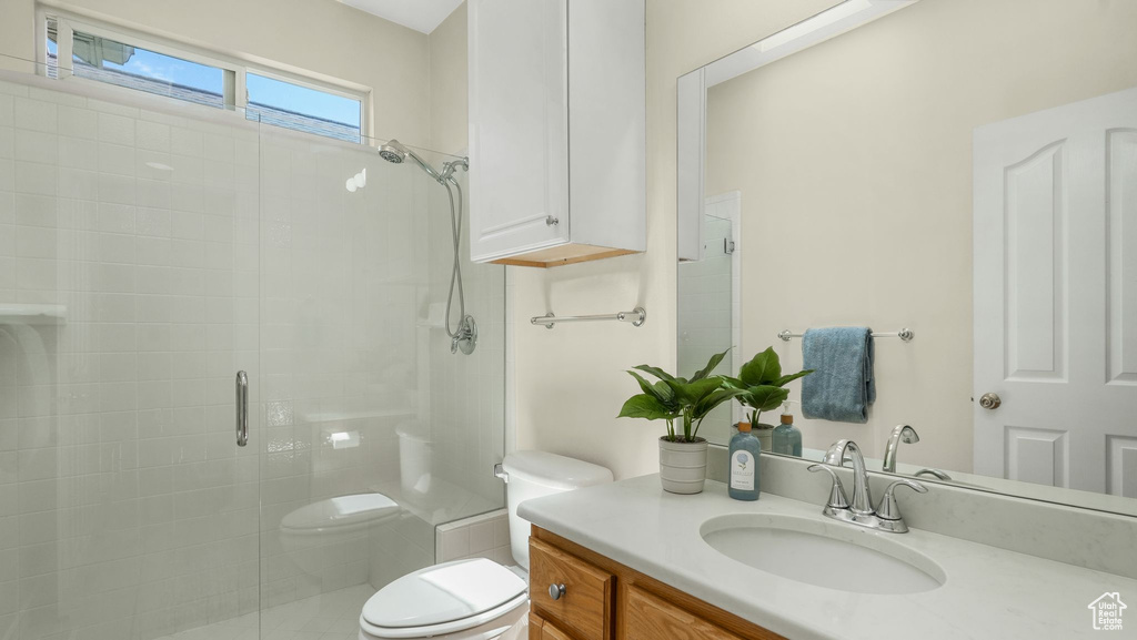 Full bath featuring a shower stall and vanity