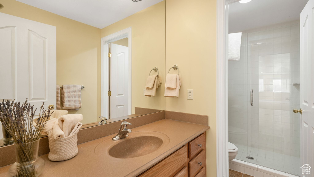 Bathroom featuring a stall shower and vanity