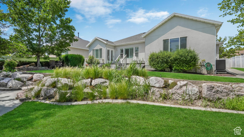 Single story home featuring a front lawn and stucco siding