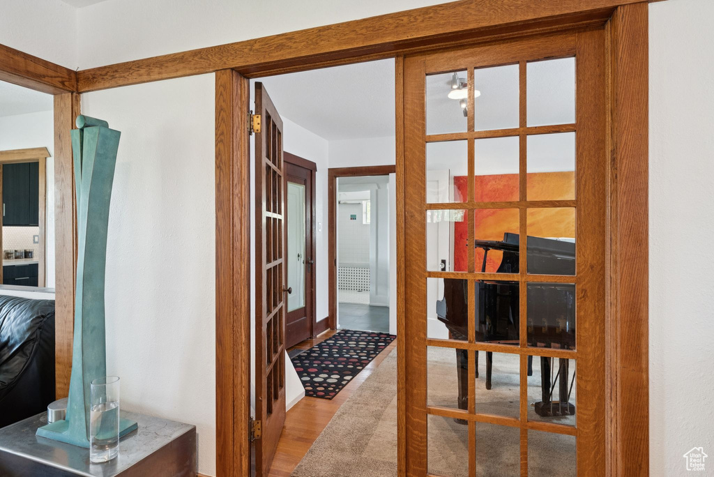 Corridor featuring wood finished floors