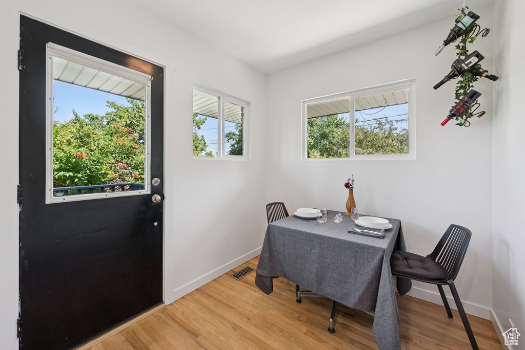 Dining space with wood finished floors and plenty of natural light