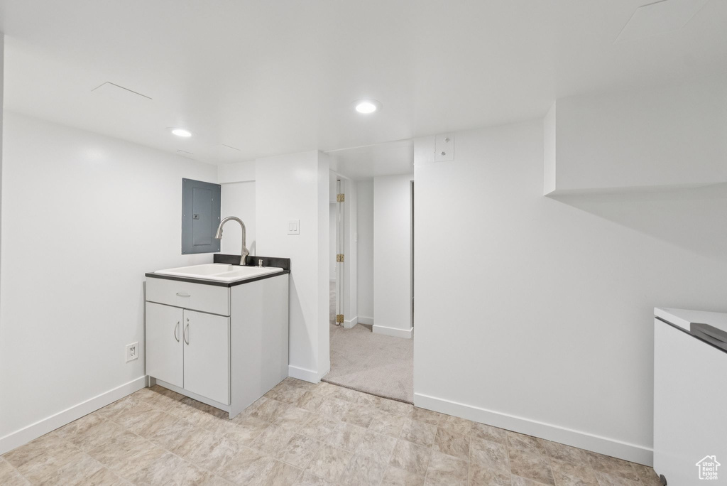 Kitchen with recessed lighting, white cabinetry, and refrigerator