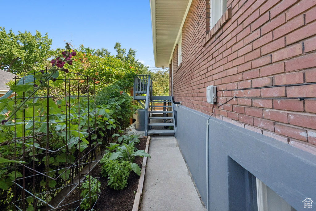 View of property exterior with brick siding