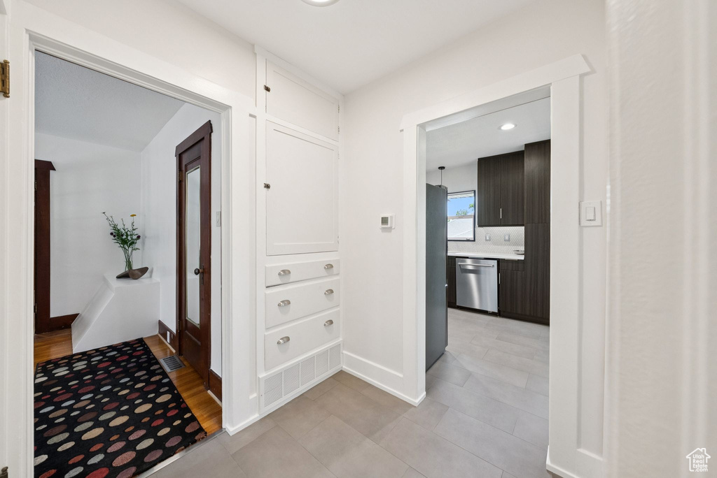 Hallway featuring light tile patterned floors and recessed lighting