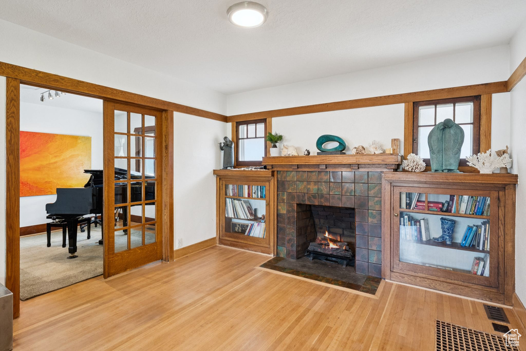 Living room featuring wood finished floors and a fireplace
