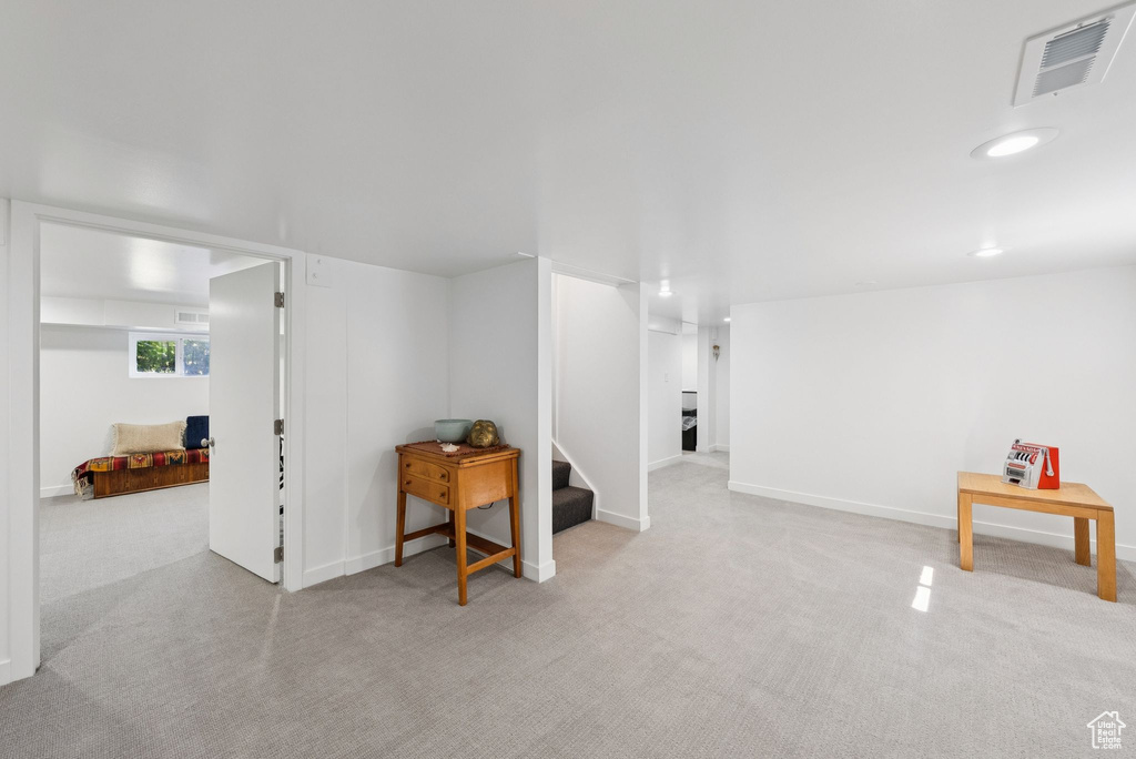 Basement with carpet floors and stairway