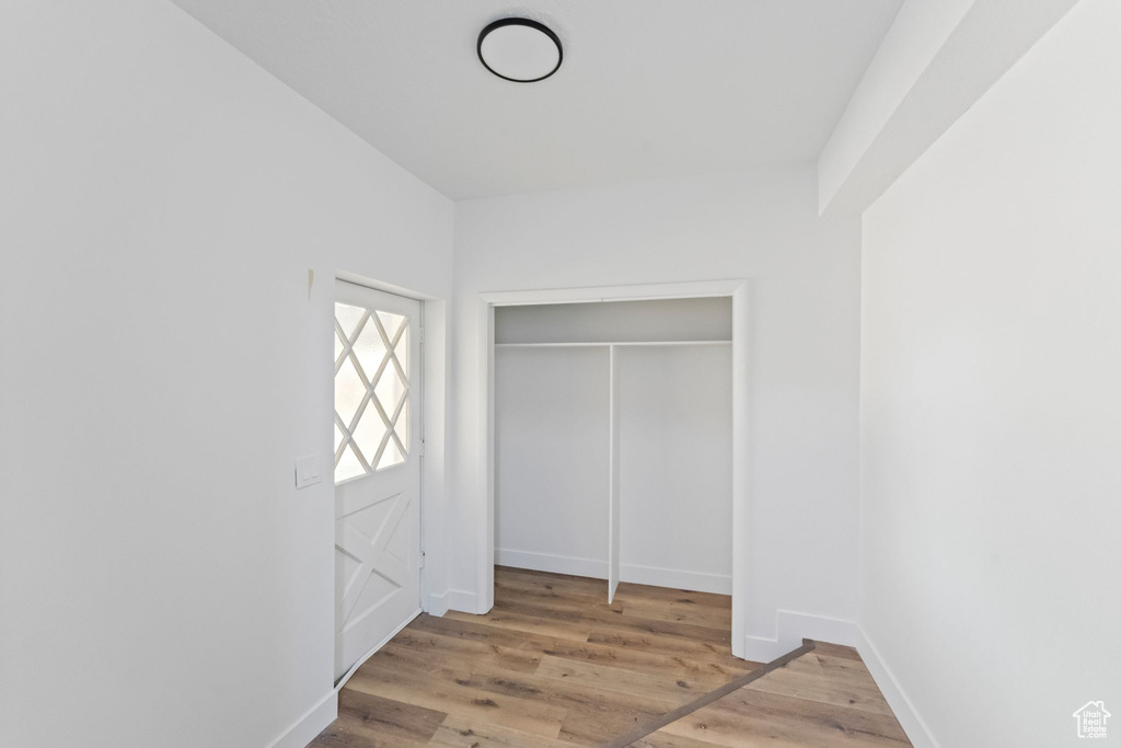 Unfurnished bedroom with light wood-type flooring and a closet