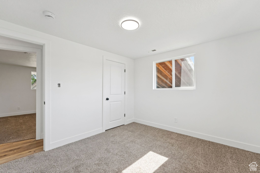 Unfurnished bedroom with carpet flooring and a closet