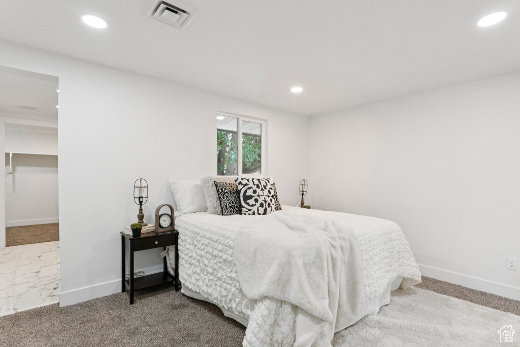 Carpeted bedroom with baseboards and recessed lighting