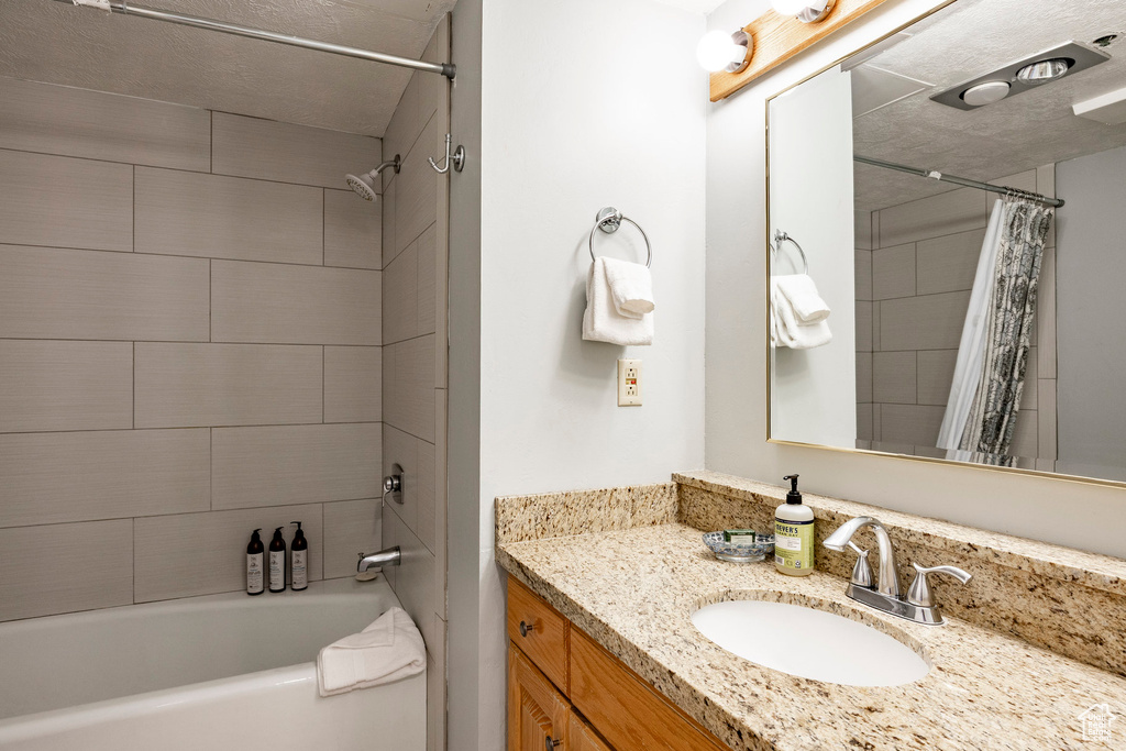 Full bathroom featuring vanity and shower / bath combo with shower curtain