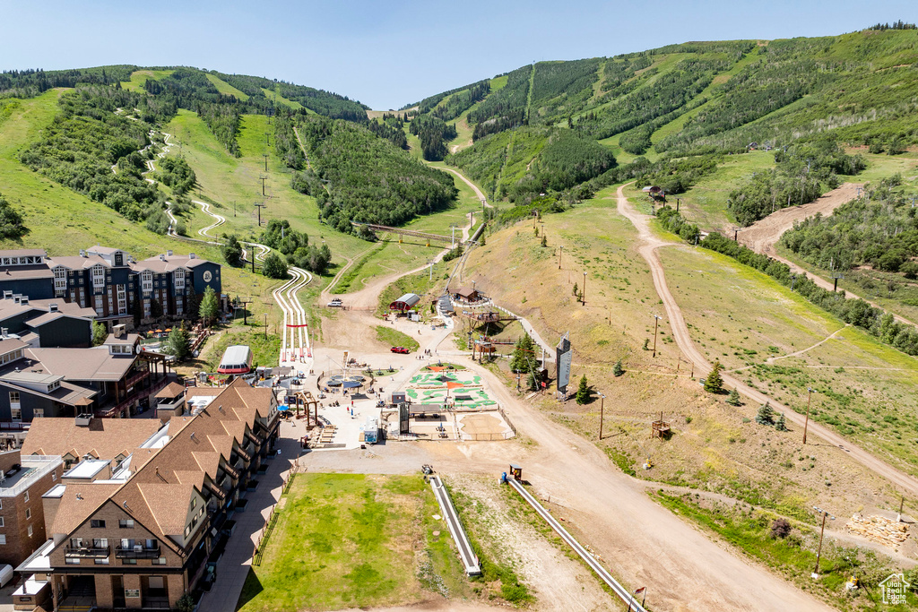 Aerial view of property's location featuring a mountainous background