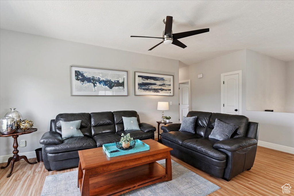 Living room featuring light wood finished floors and ceiling fan