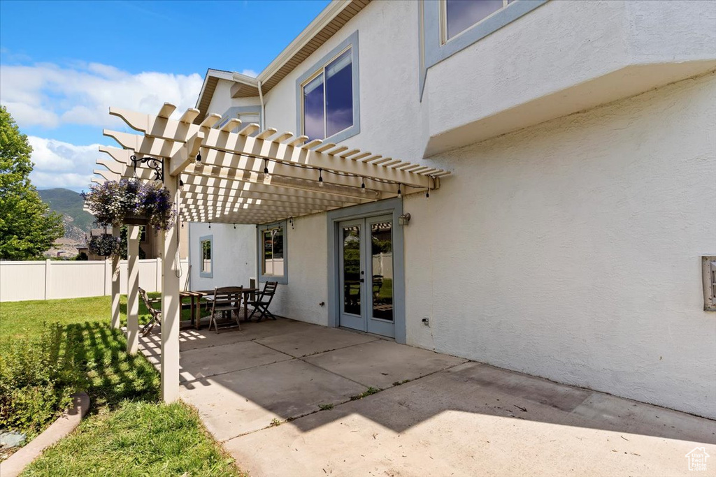 View of patio / terrace with french doors, a pergola, and a mountain view