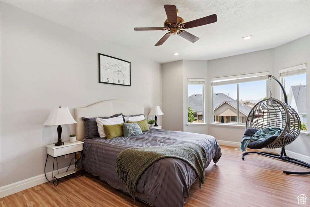 Bedroom featuring light wood-style flooring, a ceiling fan, and recessed lighting
