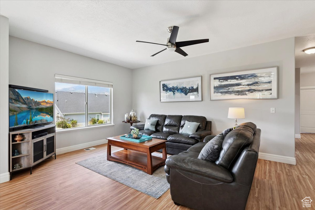 Living area featuring a ceiling fan and wood finished floors