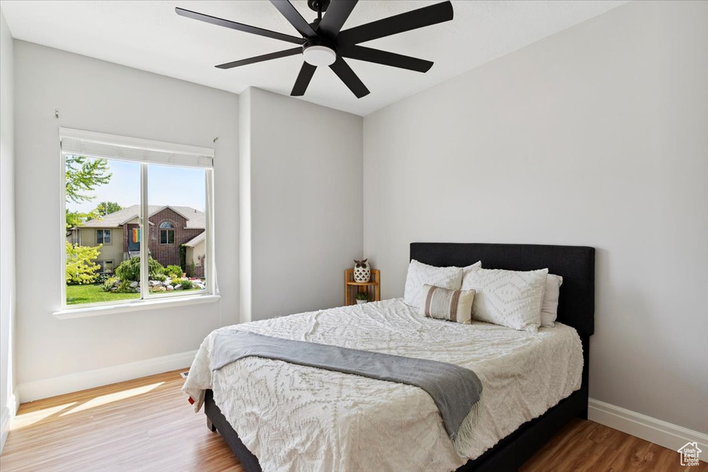 Bedroom with wood finished floors and ceiling fan