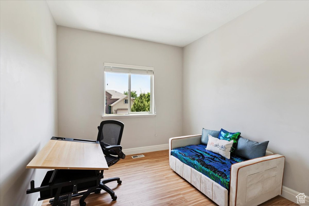 Home office featuring baseboards and wood finished floors