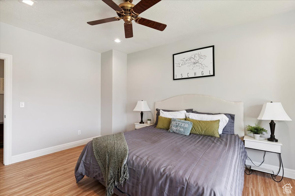 Bedroom featuring wood finished floors, ceiling fan, and recessed lighting
