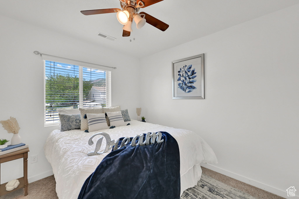 Bedroom featuring light carpet and ceiling fan