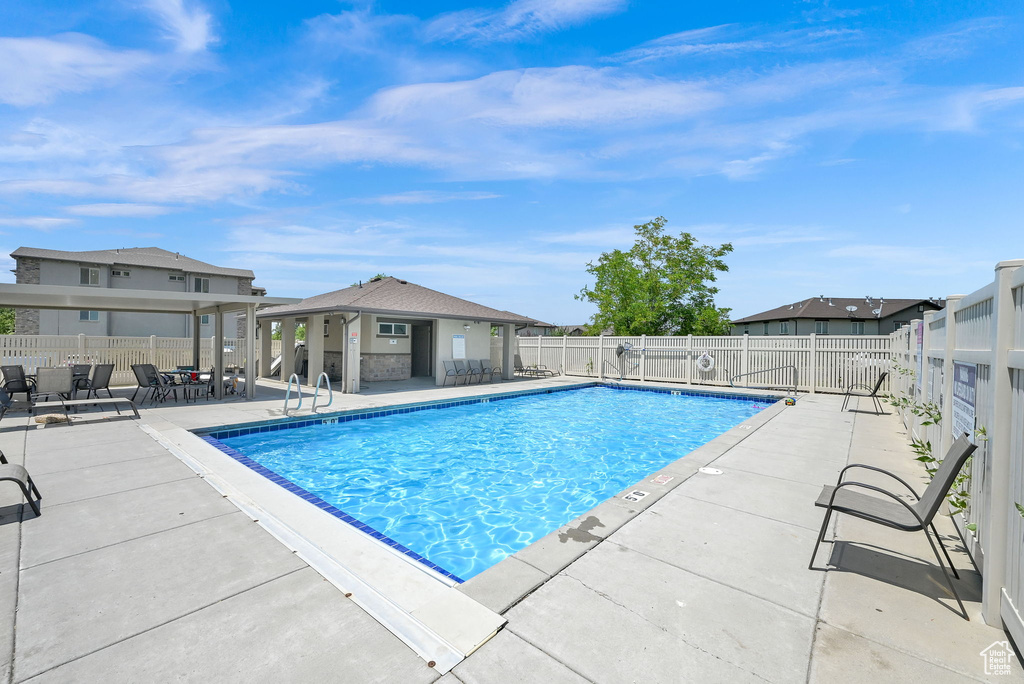 Community pool with a patio