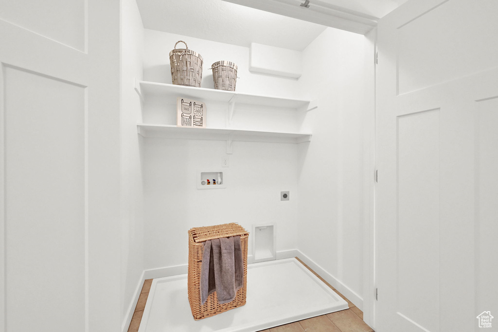 Washroom with hookup for a washing machine and electric dryer hookup